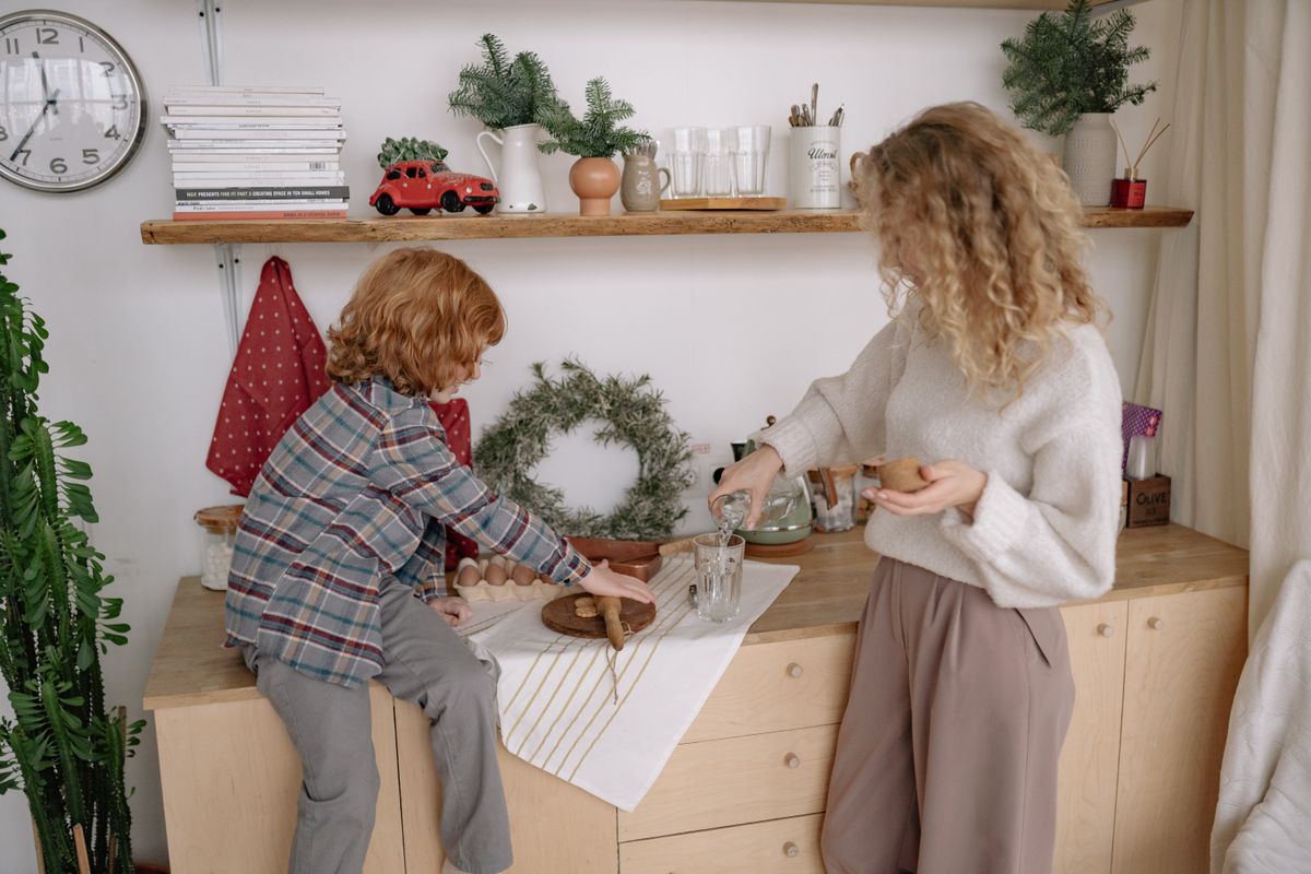 A cozy scene of a mother and child baking, surrounded by kitchen decor. Perfect for family lifestyle themes.