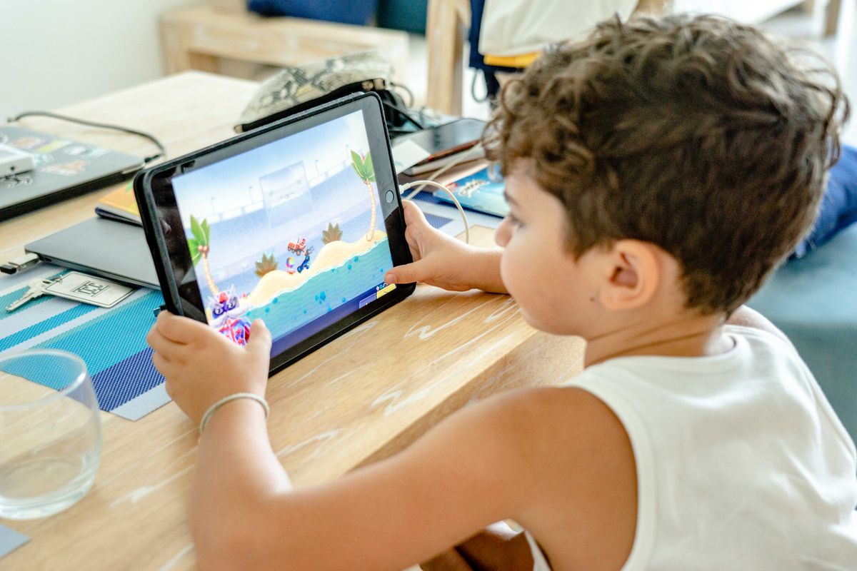 Un jeune garçon occupé à jouer à un jeu vidéo sur une tablette à la maison. - Photo par Atlantic Ambience sur Pexels