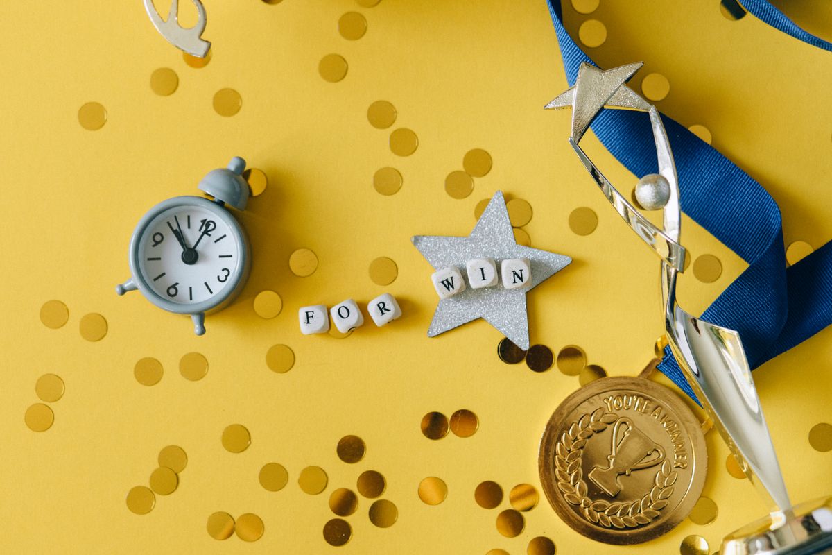 A trophy and medal reward flat lay - Photo by Nataliya Vaitkevich on Pexels