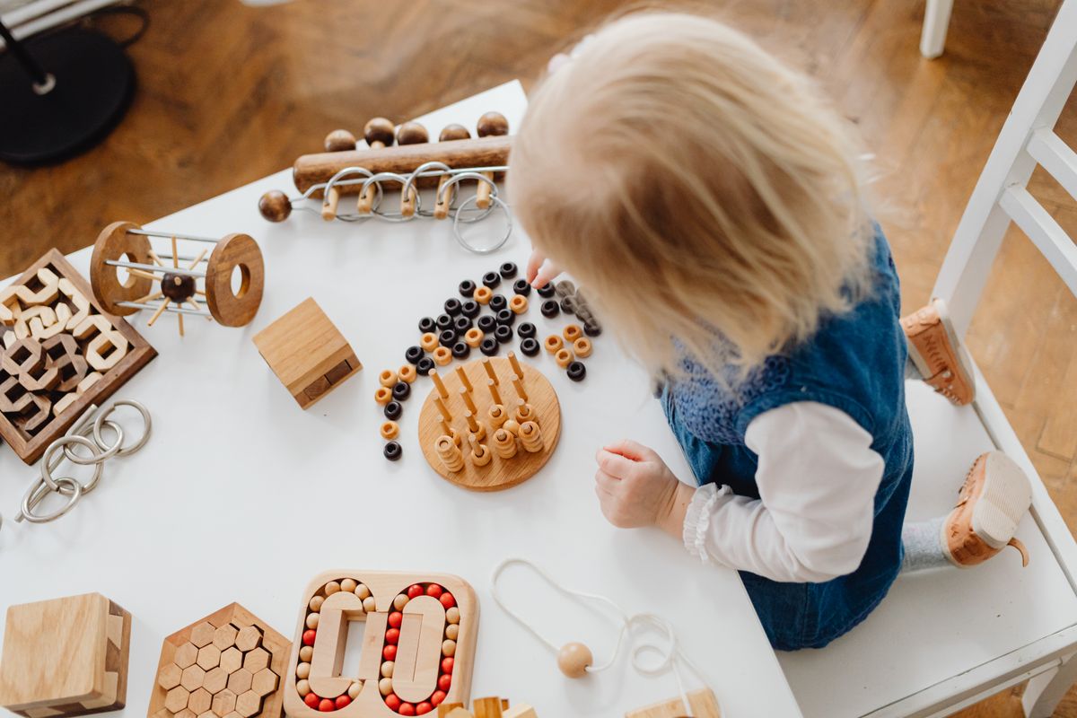 A child focused on a small play activity - Photo by www.kaboompics.com on Pexels